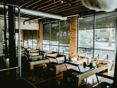 Empty, minimalist studio space with natural light, ready for a workout.